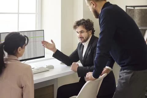 Team analyzing data during office meeting and strategy discussion workflow Stock Photos