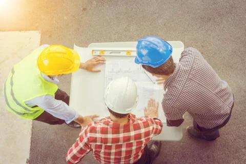 Team of Architect engineer planning group project partners meeting at site Stockfoto's