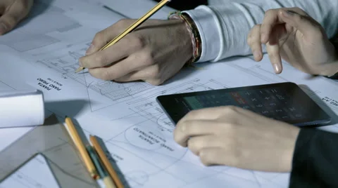 Team of architect working on blueprint with square ruler and calculator Stock Footage 49783097