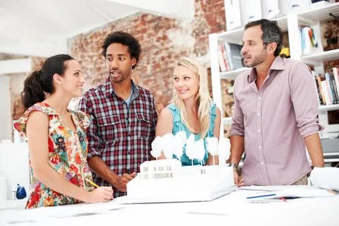 Team, architects and planning with model in office, real estate design or b.. Stock Photos