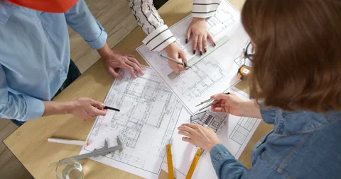 A team of architects plan and develop sketch design drawings of a construction  Stock Footage 201694000