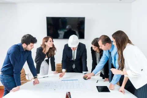 Team of architects presenting construction project. Engineers and Architects  Stock Photos