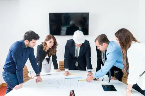 Team of architects presenting construction project. Engineers and Architects  Stock Photos