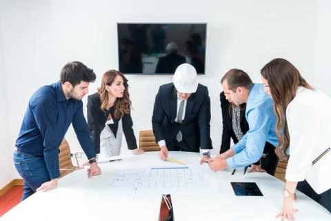 Team of architects presenting construction project. Engineers and Architects  Stock Photos