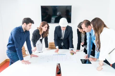Team of architects presenting construction project. Engineers and Architects  Stock Photos