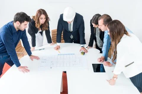 Team of architects presenting construction project. Engineers and Architects  Stock Photos