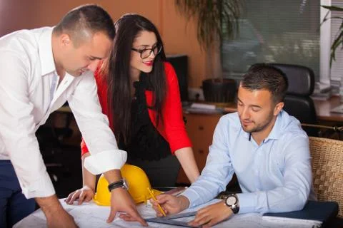Team of architects working on construction plan in the office Stock Photos