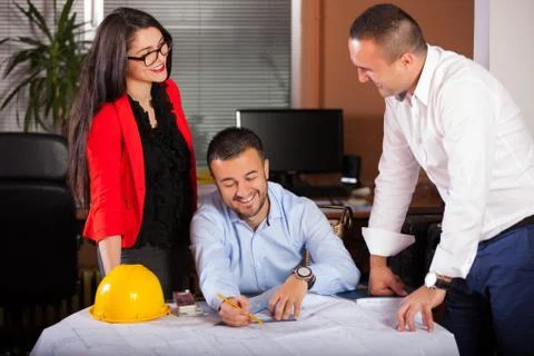 Team of architects working on construction plan in the office Stock Photos