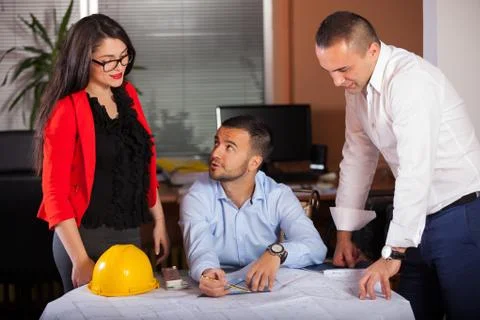 Team of architects working on construction plan in the office Stock Photos