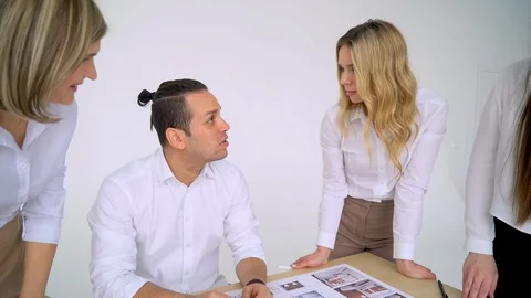 Team of architects working together, examining blueprints, choosing, talking Stock Footage 88620752