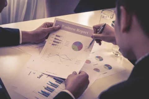 Team are working together analyzing business data on the table Stock Photos