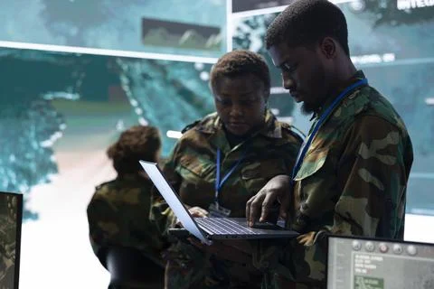 Team of army conscripts collecting information from military radar surveillance Stock Photos