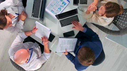 Team around laptop practicing pitch presentation with mentor review, team Stock Footage 319565810
