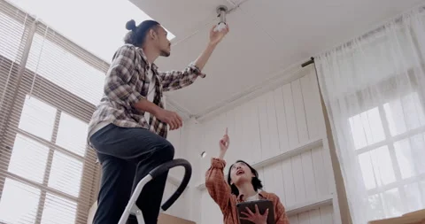 Team Asian contractor is provide maintenance services repairing install lamp Stock Footage 162154394