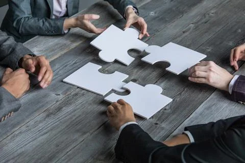 Team assembling jigsaw puzzle Stock Photos