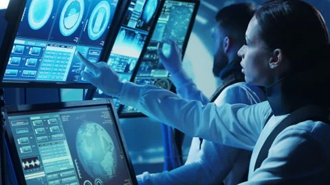 Team of astronauts in a space suits aboard the orbital station. A crew of Stock Footage 225694999