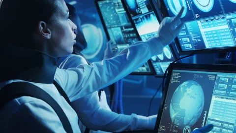 Team of astronauts in a space suits aboard the orbital station. A crew of Stock Footage 225700605