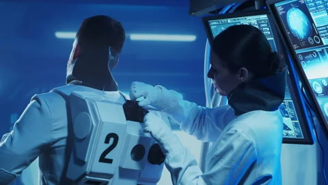 Team of astronauts in a space suits aboard the orbital station. A crew of Stock Footage 230147672