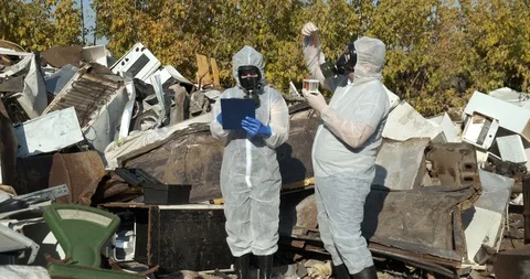 Team of biologists is in landfill, checking pollution samples, shakes test tube Stock Footage 119052035