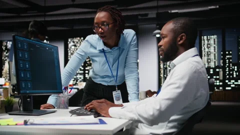 Team of black IT experts use online AI assistant to automate text generation Stock Footage 318498218