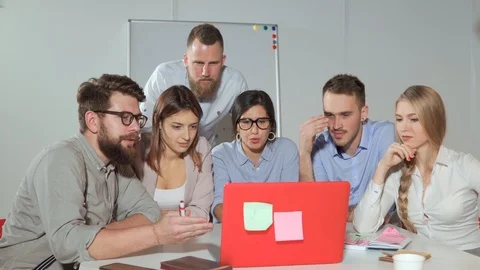 Team brainstorming in front of a laptop. Stock Footage 109073664