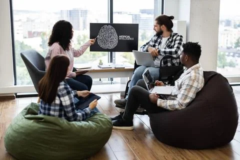 Team brainstorming session discussing artificial intelligence project in office Stock Photos