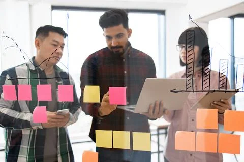 Team brainstorming session with sticky notes and charts Stock Photos