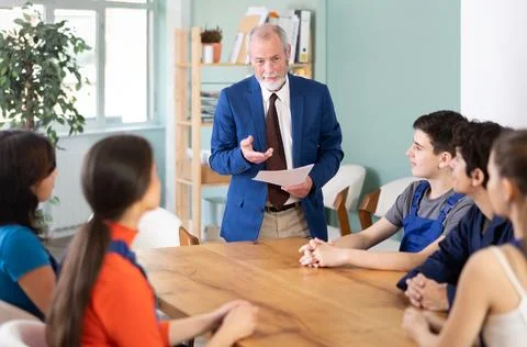 Team of builders and foremen sits at the table and listens to the tasks Stock Photos