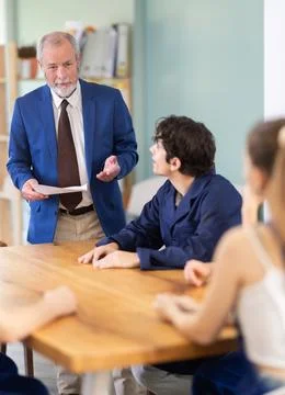 Team of builders and foremen sits at the table and listens to the tasks Stock Photos