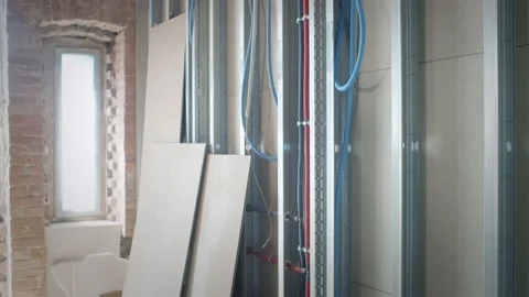 Team of builders fitting insulation fiber to room walls Stock Footage 133639117