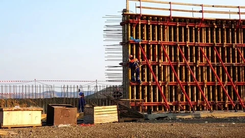 A team of builders install a formwork for a concrete wall Stock Footage 74001893