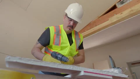 A team of builders is renovating a house, showcasing their teamwork and Stock Footage 306046005