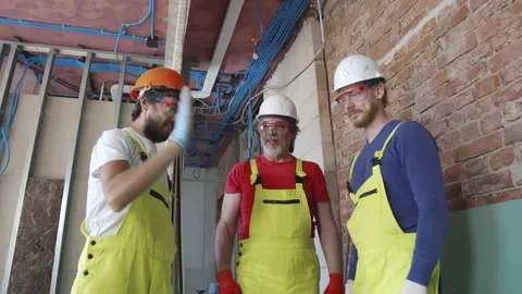 Team of builders standing with hands clasped together Stock Footage 133637461