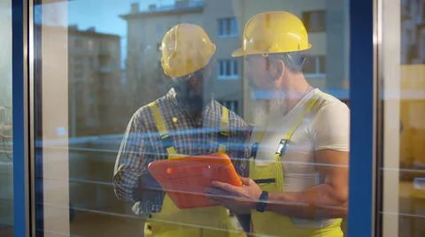 Team of builders with tablet computer working indoors Stockfoto's