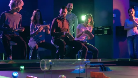 Team building at amusement arcade, playing Chasing game Stock Footage 115283133