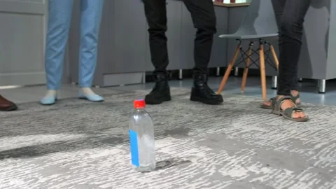 Team-building bottle flip game in office Stock-Footage 316064991