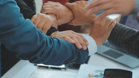 Team building with employees joining hands demonstrating partnership unity Stock Footage 325351466
