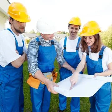 Team of buildres with plan Stock Photos