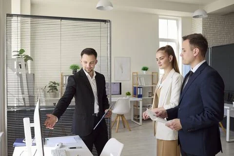 Team of business analysts presenting data and strategy at office computer Stock Photos