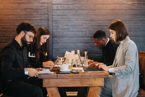 Team of business professionals collaborating at a work desk in casual 스톡 사진