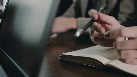 A team of businessmen is preparing to record important information in notebooks. Stock Footage 89668452