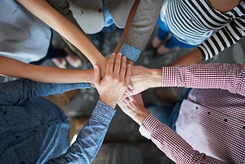 Team can-do. Top view of co-workers hand put together in an expression of unity Stock Photos