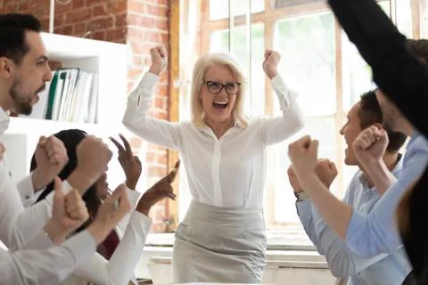 Team celebrating corporate success screaming with joy feels happy Stock Photos