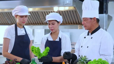 Team chef instruction and explaining apprentice about cooking and preparing.. Stock Footage 237874523