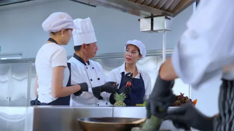 Team chef instruction and explaining apprentice about cooking and preparing.. Stock Footage 239922568