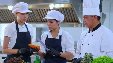 Team chef instruction and explaining apprentice about cooking and preparing.. Stock Footage 239925240