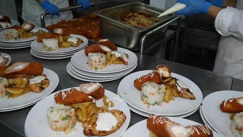Team of chefs working at the order station in a commercial kitchen Stock Footage 128359212