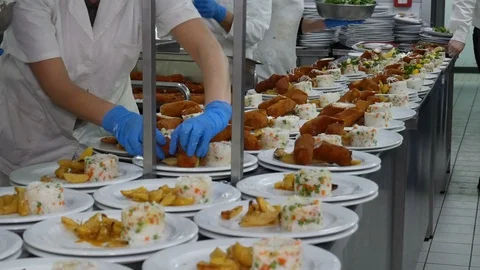 Team of chefs working at the order station in a commercial kitchen Video stock 128359421