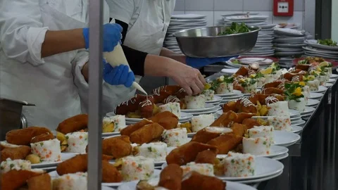 Team of chefs working at the order station in a commercial kitchen Video stock 128359488