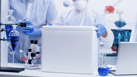 Team of chemist scientists opening a refrigerator box in a modern research Stock Footage 114553630